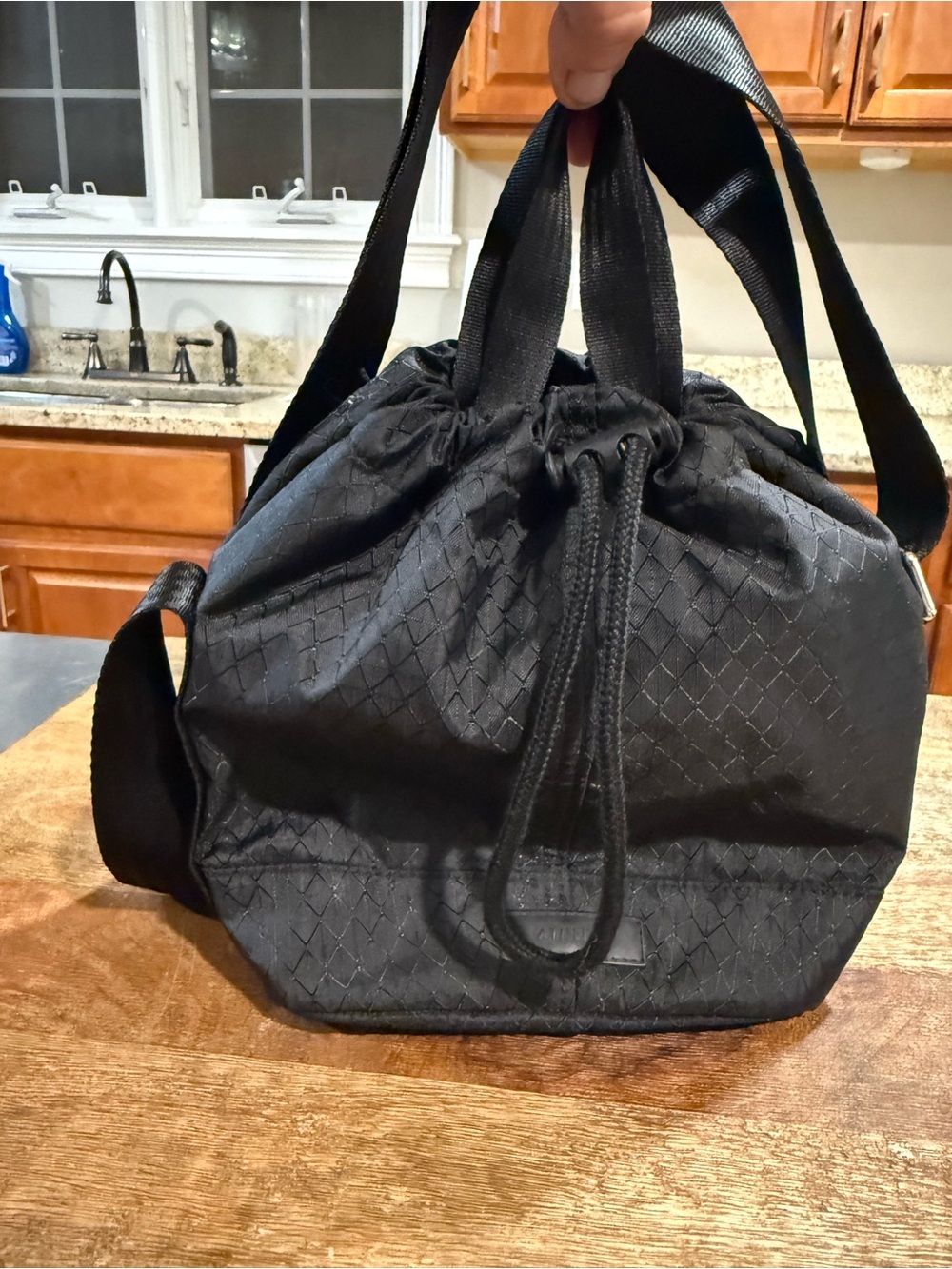 This is the Athleta Excursion Crossbody Bucket Bag in black
